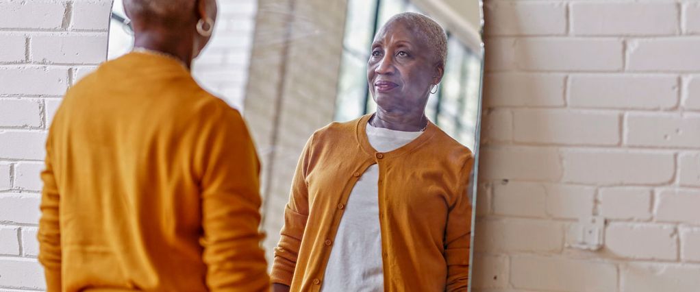 An image of a woman looking in the mirror