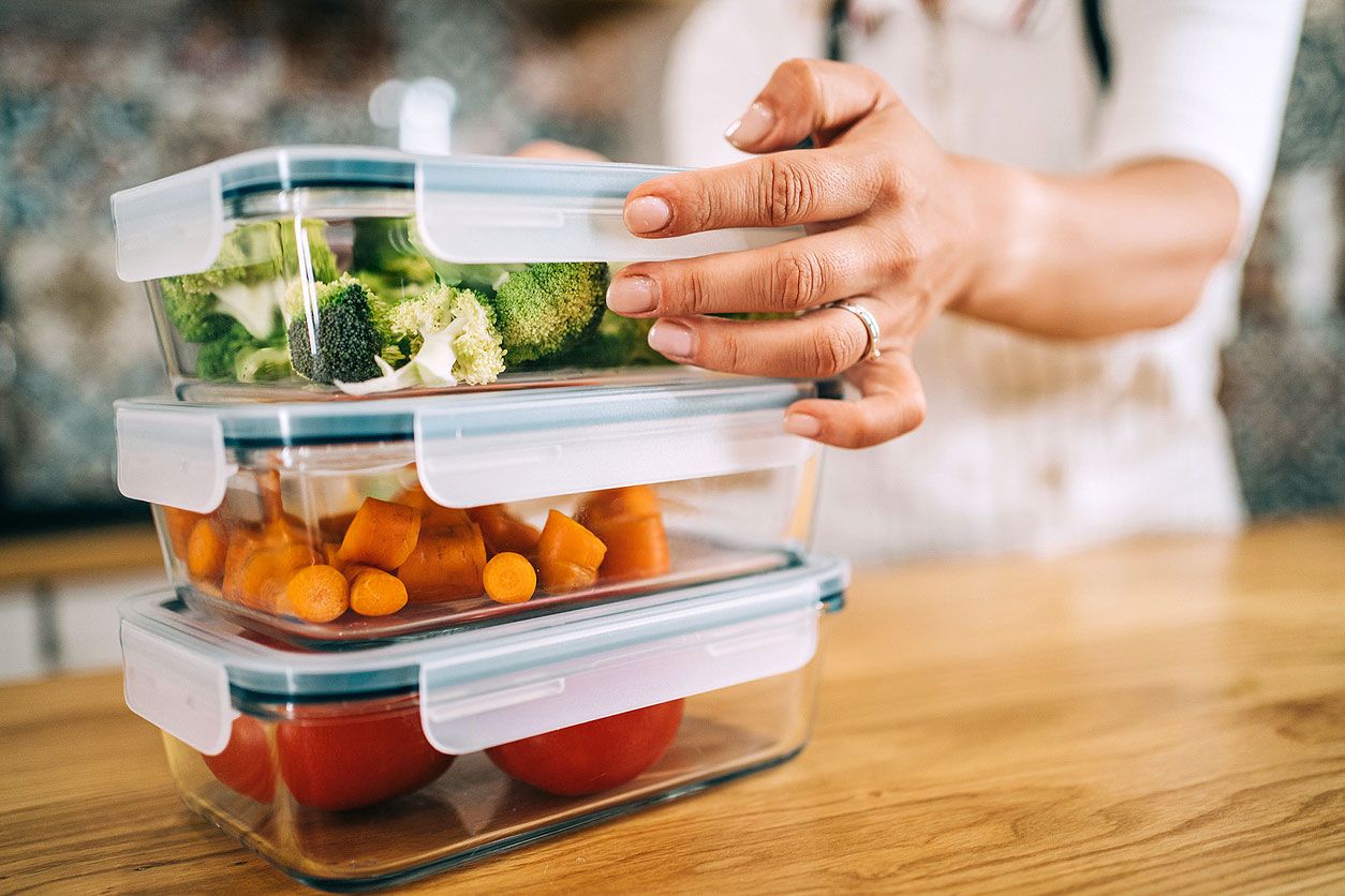 An image of three staked containers with vegetables in them