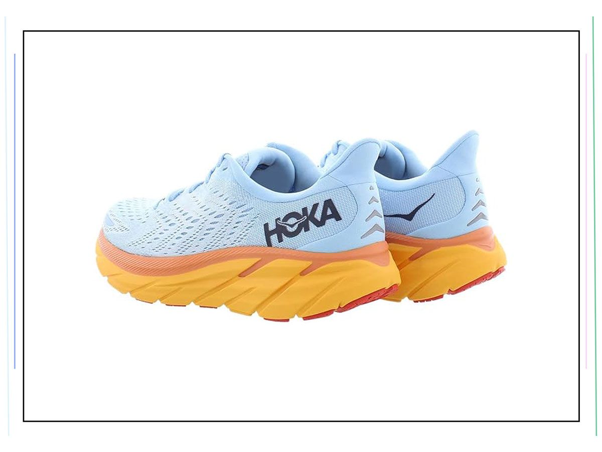 An image of blue sneakers with orange soles