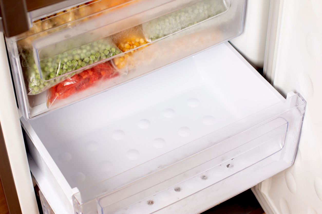 An empty bottom drawer in the freezer