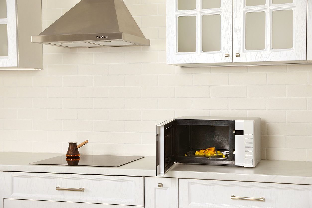 An image of an open microwave on a kitchen counter