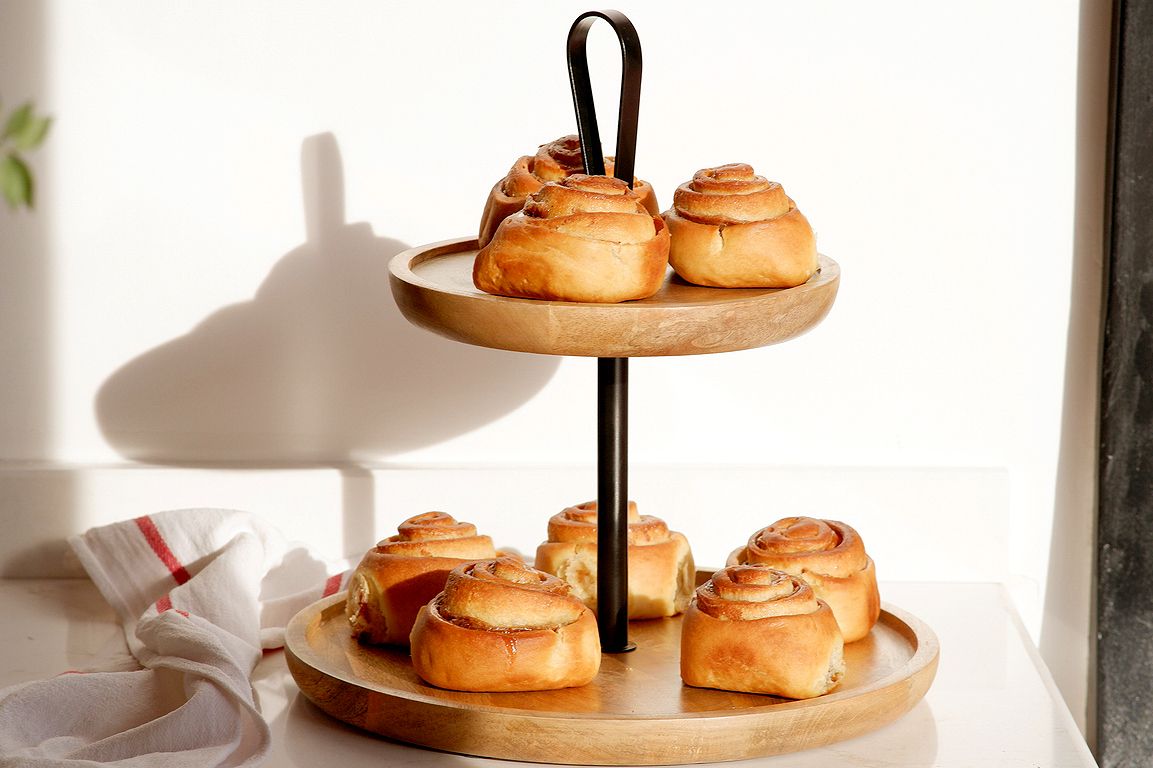 An image of cinnamon rolls on a tiered serving dish