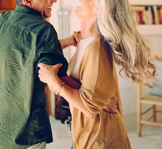 An image of a man and a woman dancing in a living room