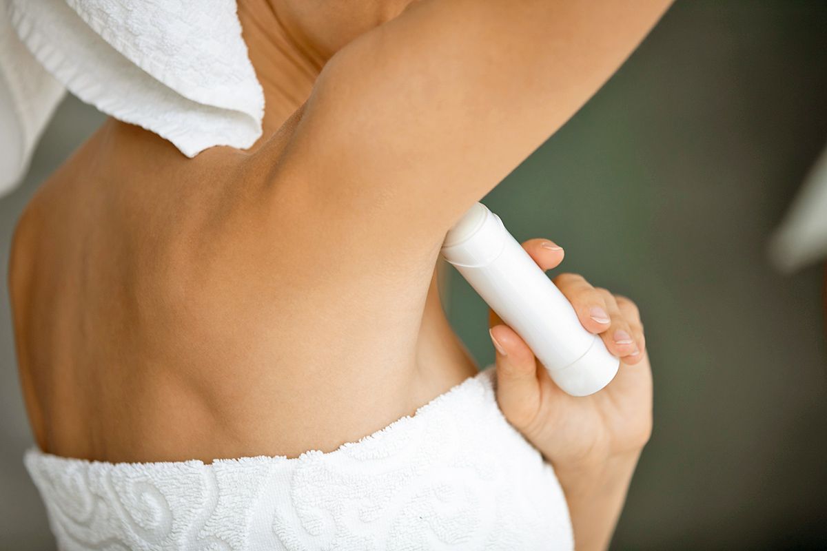 Woman applying deodorant