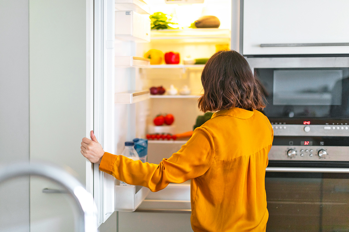 Woman opening fridge