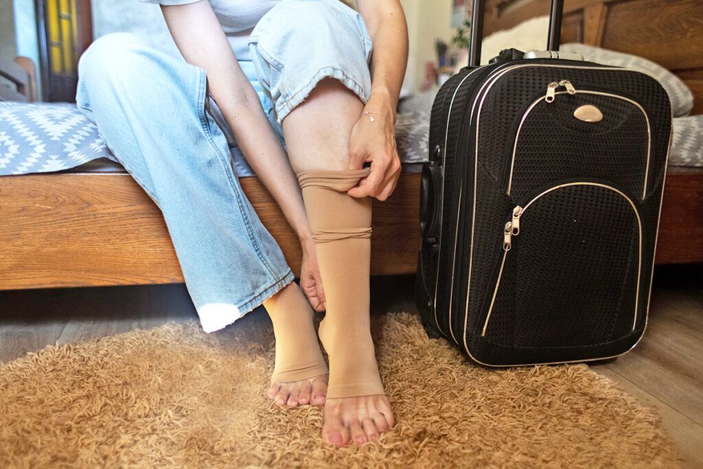 Person putting on compression socks