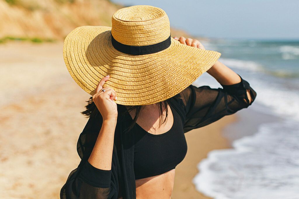 Woman wearing hat on beach