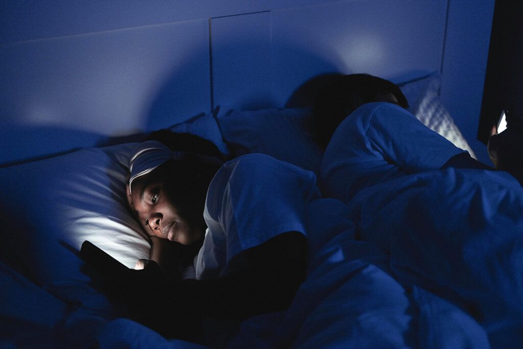 Woman on phone in bed