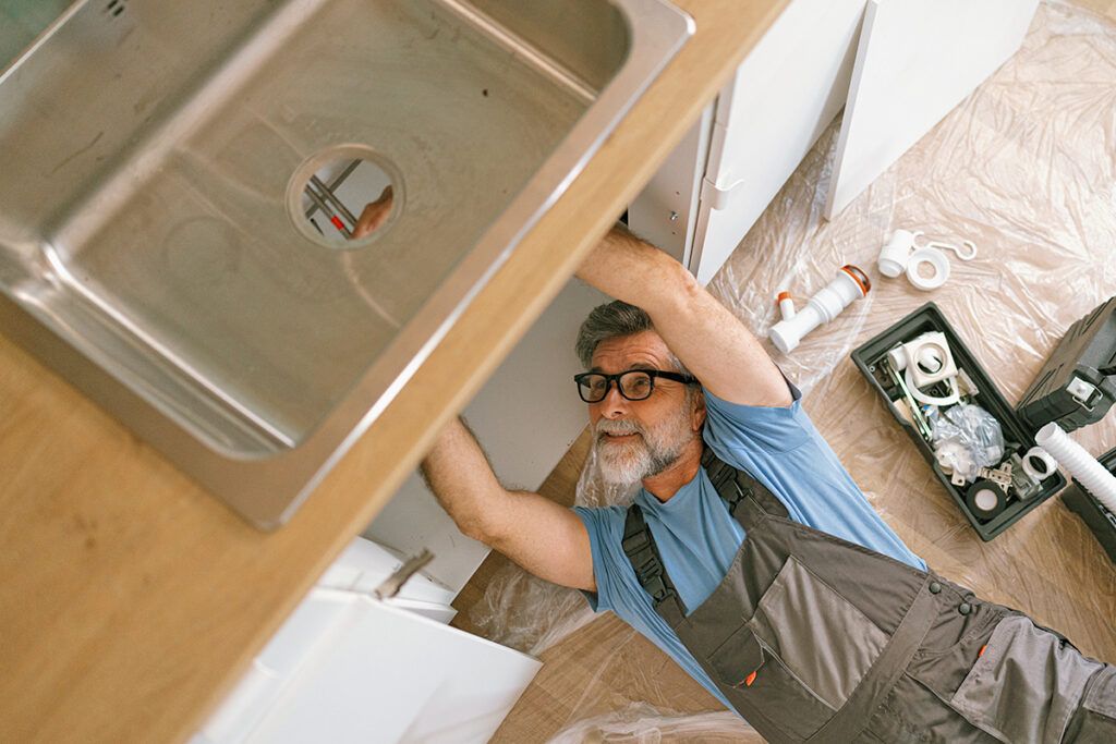 Plumber working on sink