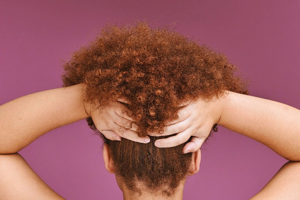 Woman holding up curly hair