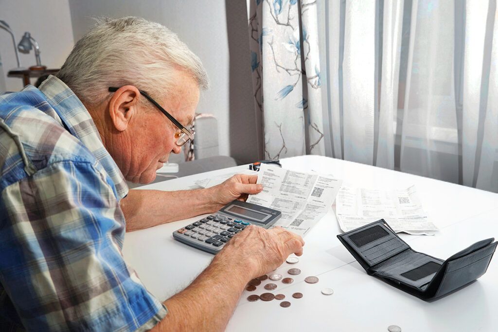 Older man looking at his bank statement
