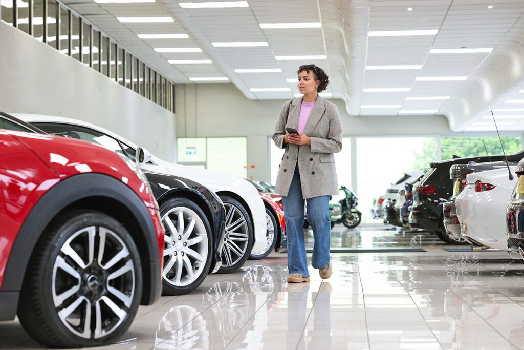 Woman in car showroom