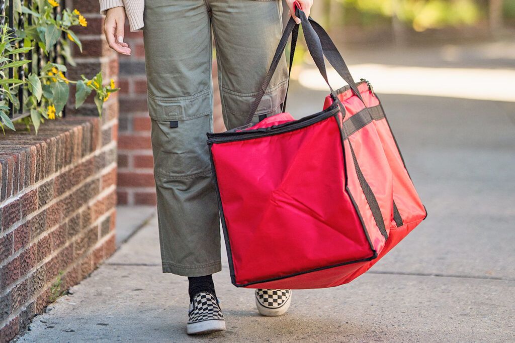 Person carrying insulated food bag