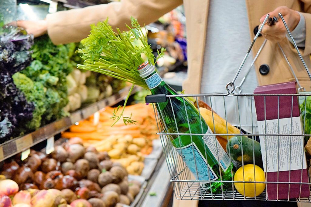 Sparkling water and food in a shopping basket
