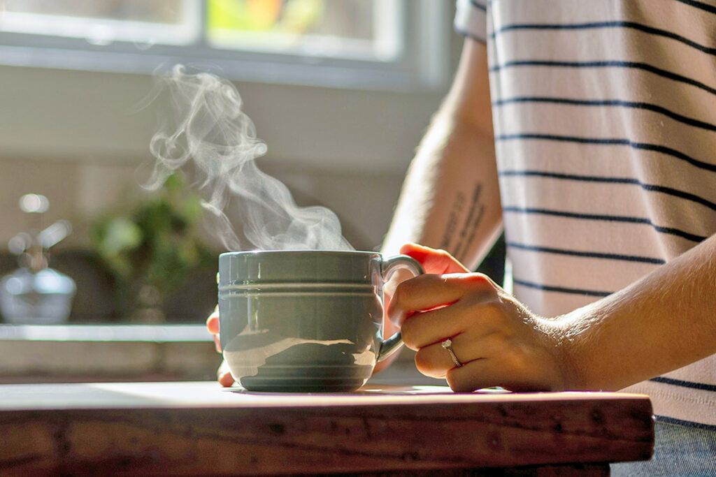 Woman holding hot beverage
