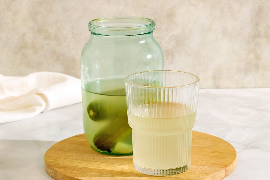 Pickle juice in jar and glass
