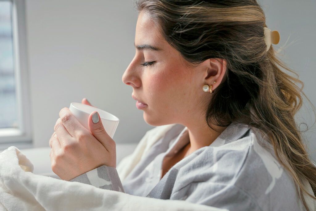 Woman drinking hot beverage