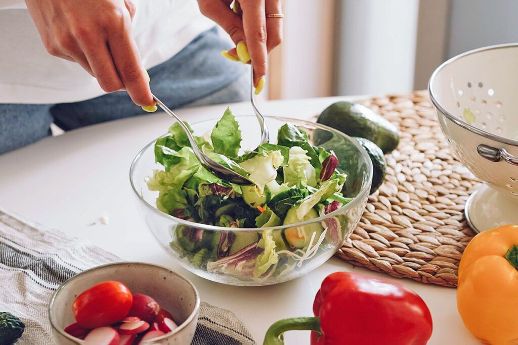 Person preparing salad
