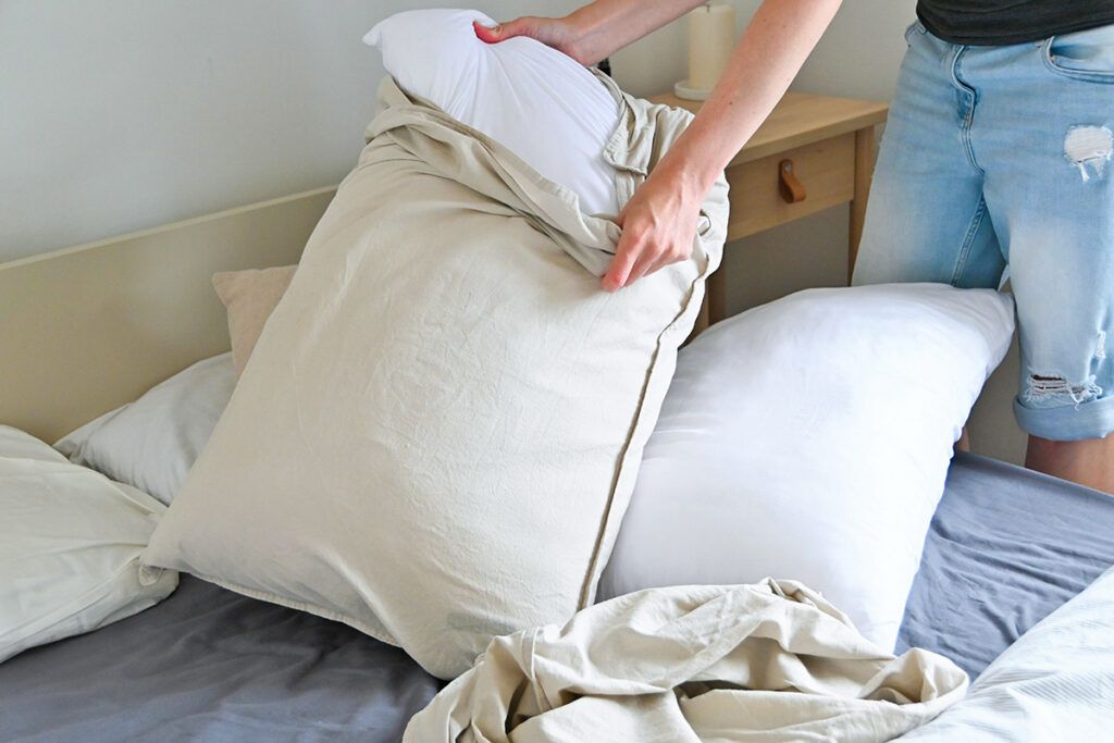 Person pulling pillow out of pillowcase