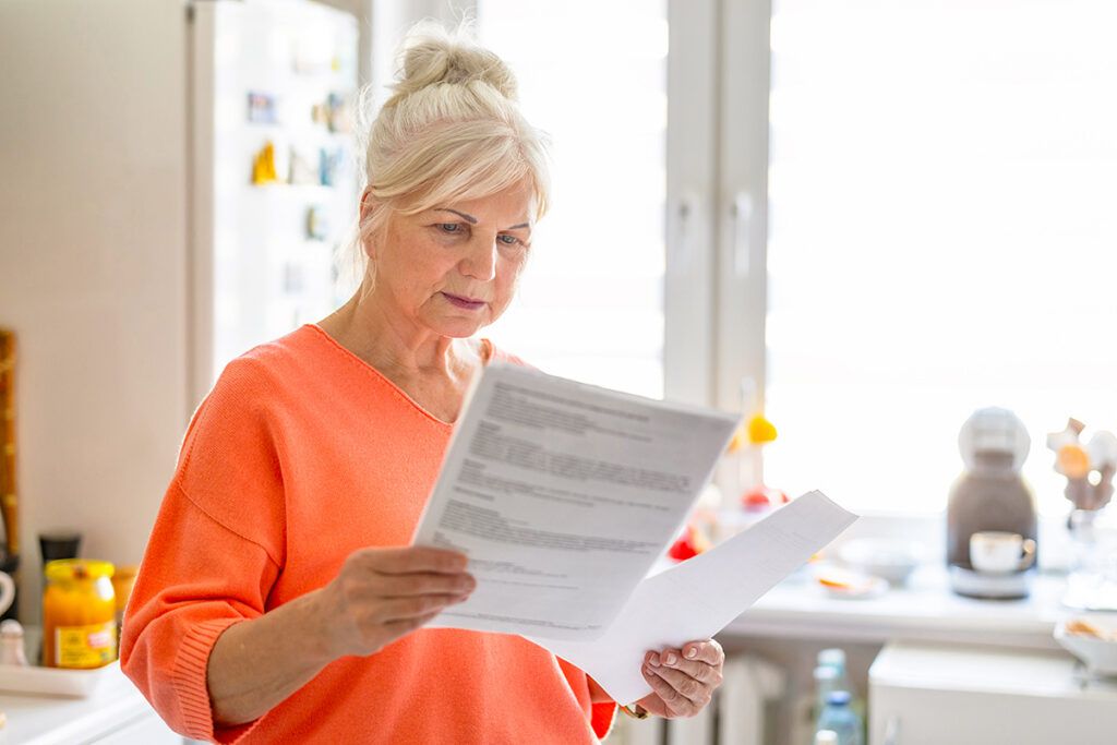 Older woman looking at papers