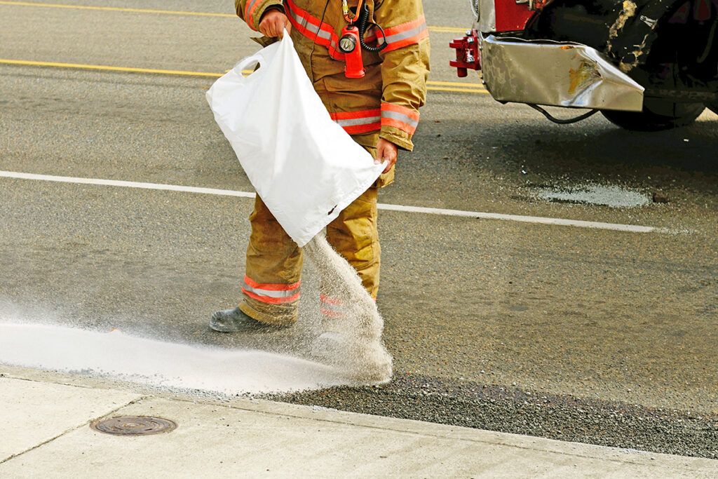 Firefighter putting down something at wreck