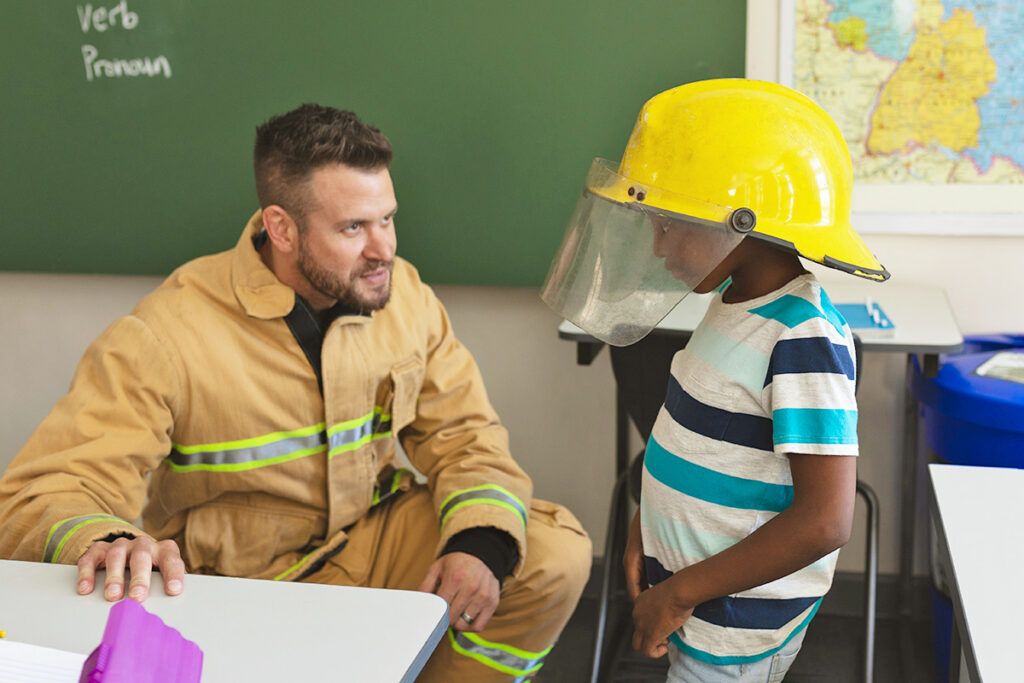 Firefighter with student at school