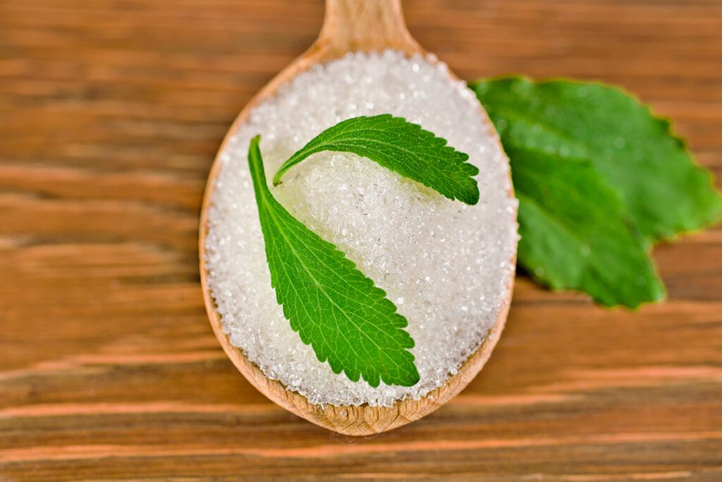 Stevia leaves and stevia on a spoon