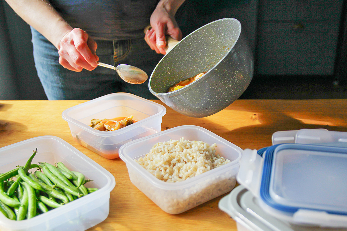 Putting leftovers in food storage containers
