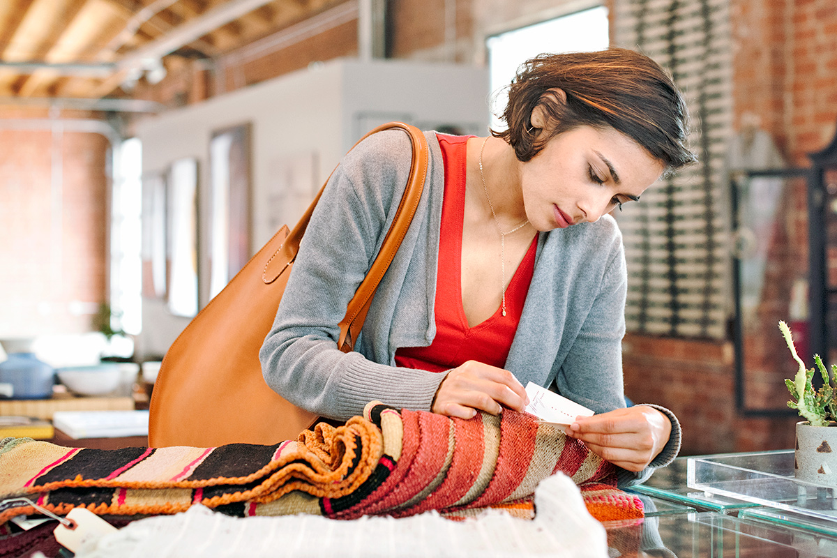 Woman checking price tag on clothing