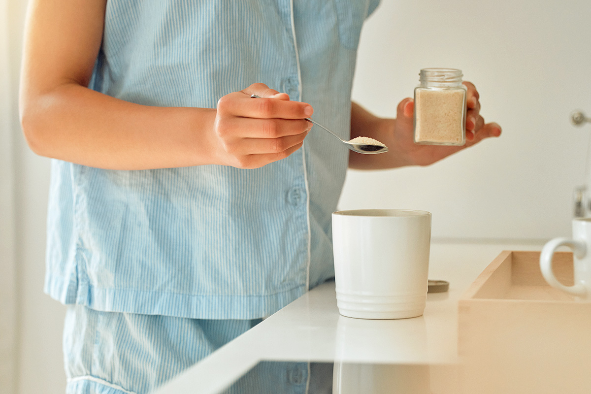 Woman with spoon of sugar