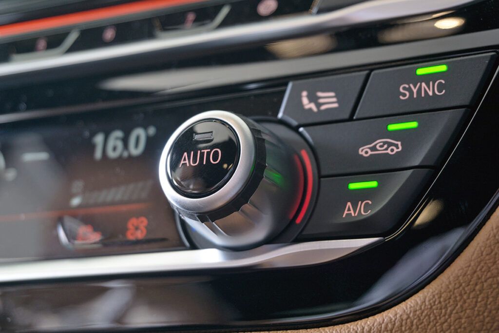 Car dashboard with buttons lit up in green