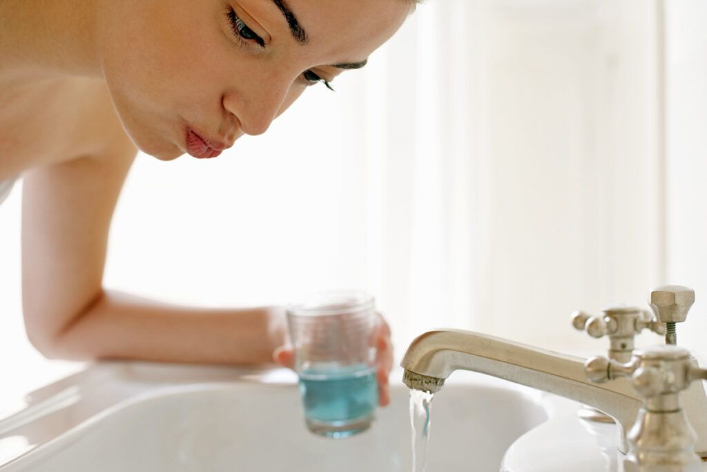 Woman hovering over sink