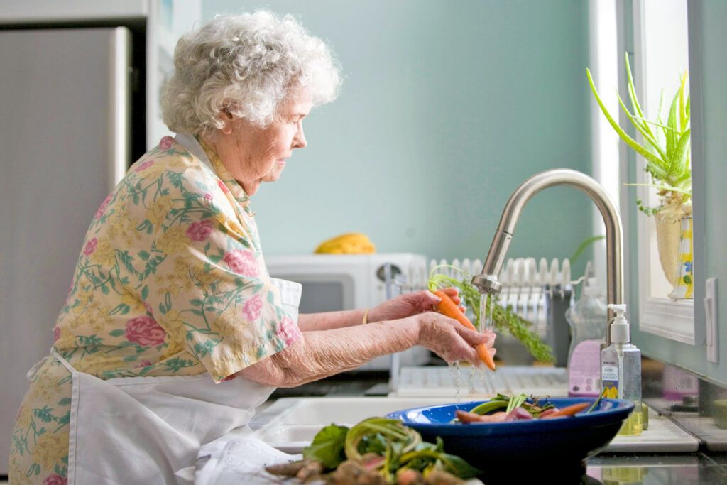 Older woman washing carrots