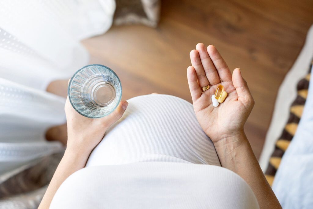 Pregnant person with supplements