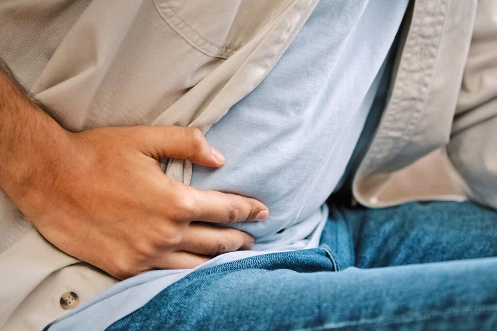 Hand holding stomach