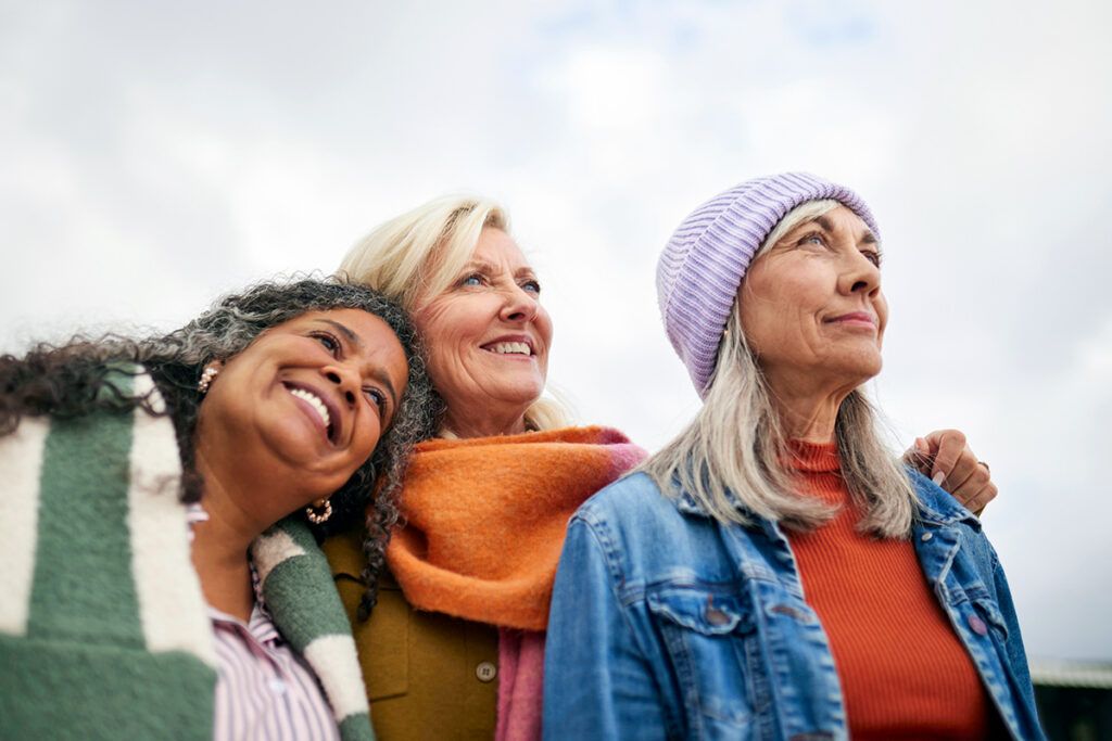 Three older women smiling