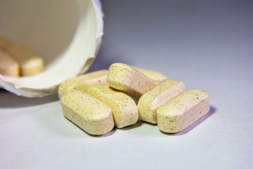 Pills coming out of a bottle