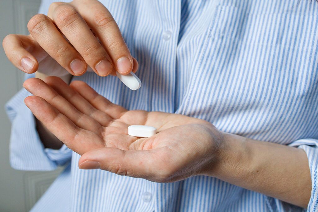 White tablets in hand