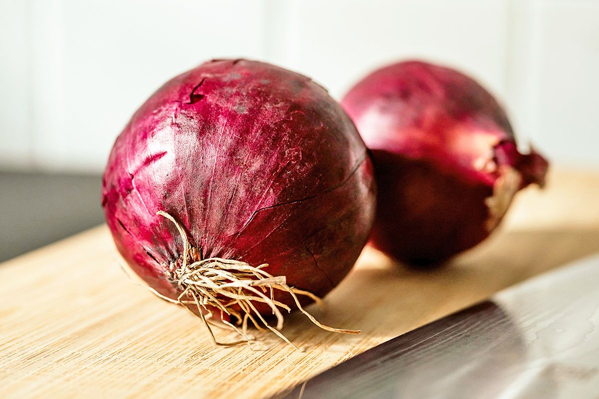 Red onions on cutting board