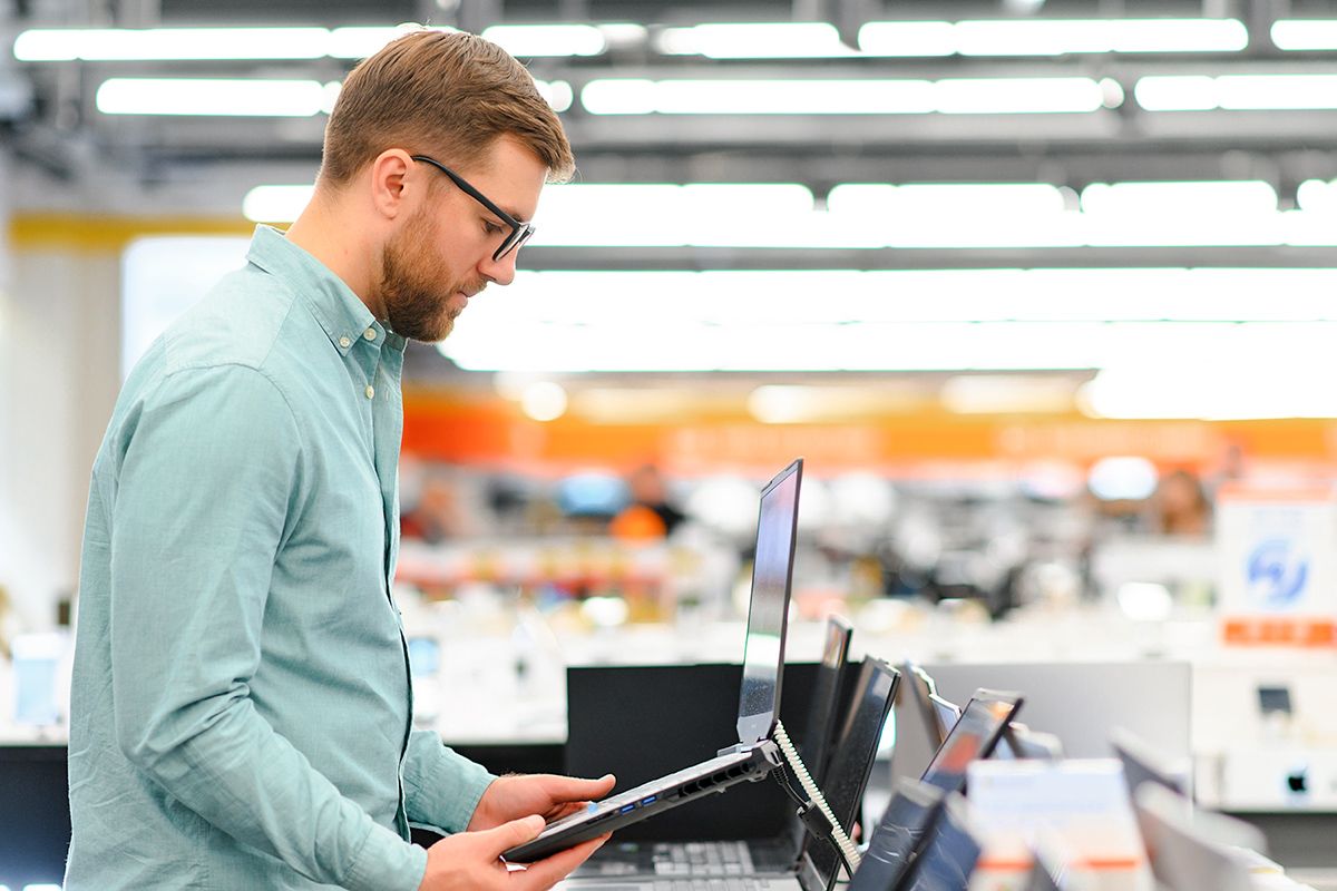 Man looking at laptop in store