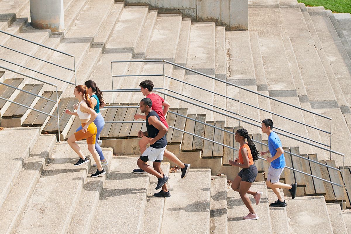 Group of people running up the stairs