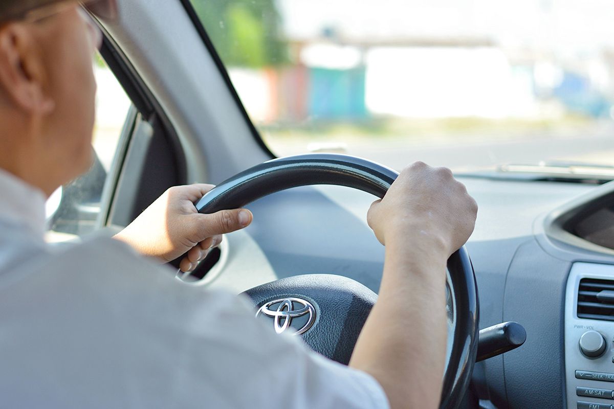 Person with hands on steering wheel