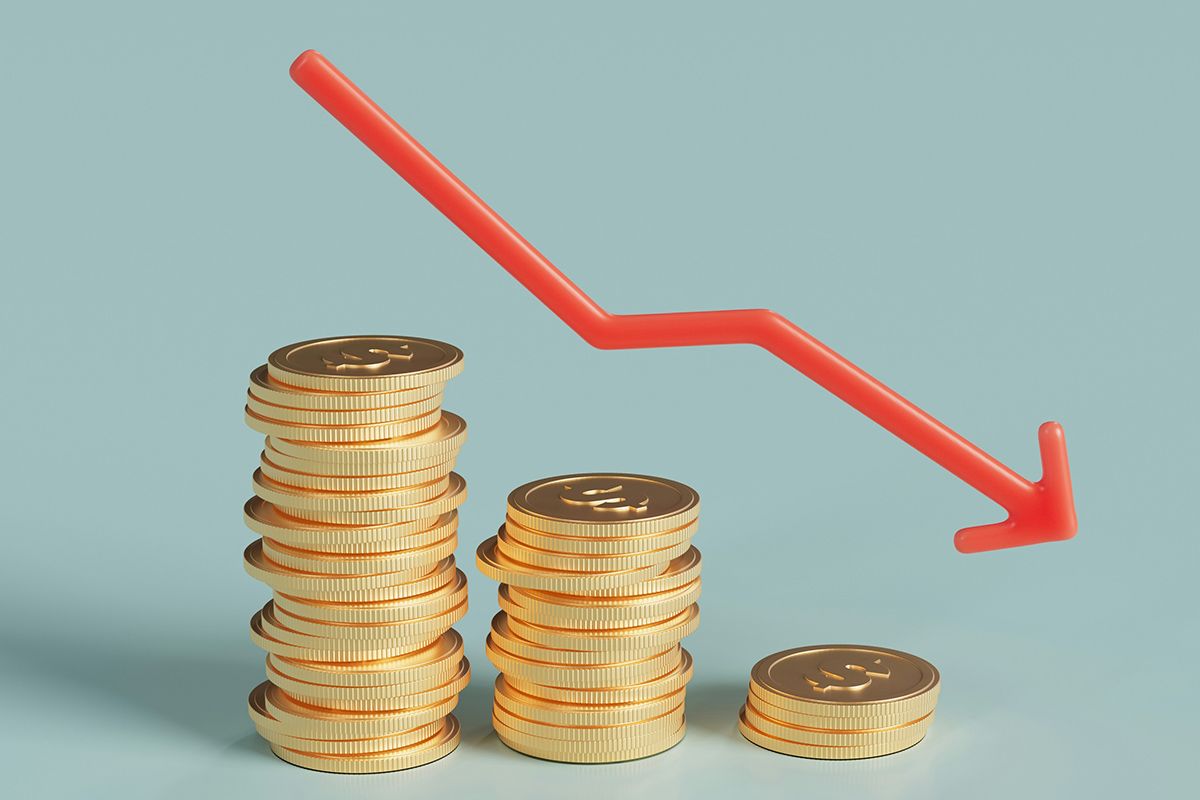 Stack of coins with red arrow pointing downward
