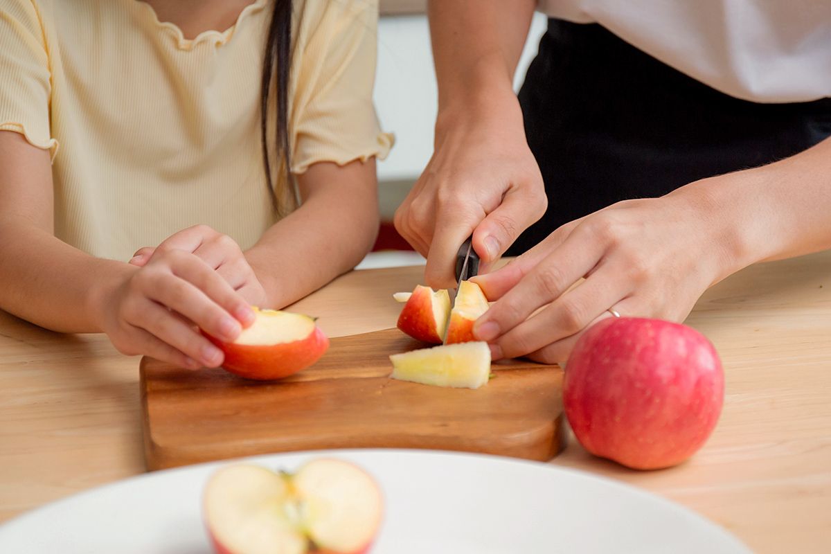 Cutting up apples on a cutting board