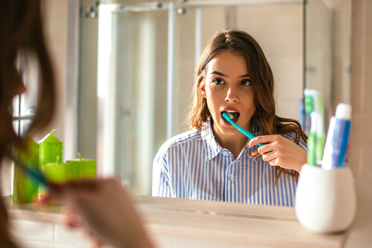 Woman brushing teeth