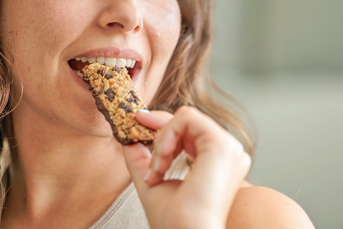 Woman eating granola bar