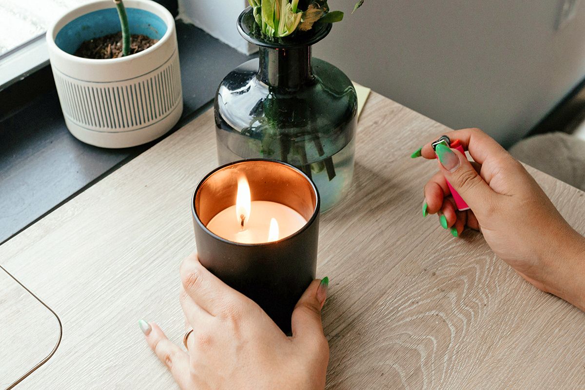 Lit candle on desk