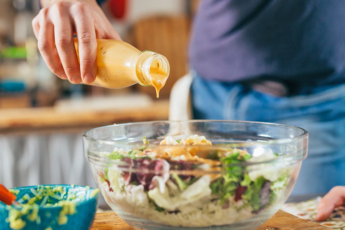 Pouring dressing on salad