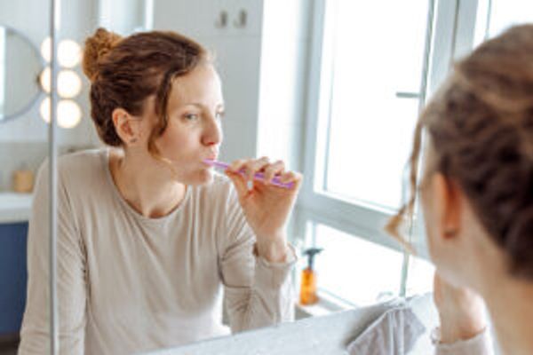 Woman brushing teeth