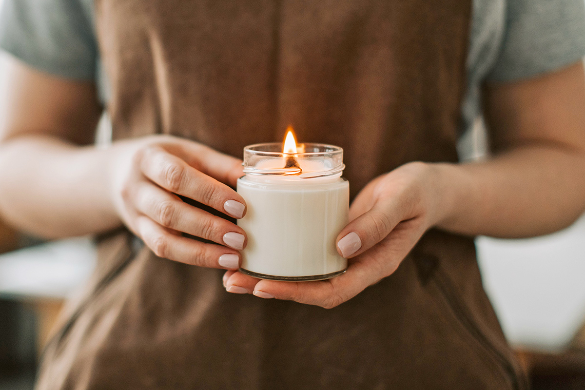 Person holding lit candle